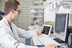 Pharmacist working at a computer