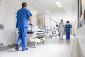 Doctors Hospital Corridor Nurse Pushing Gurney Stretcher Bed